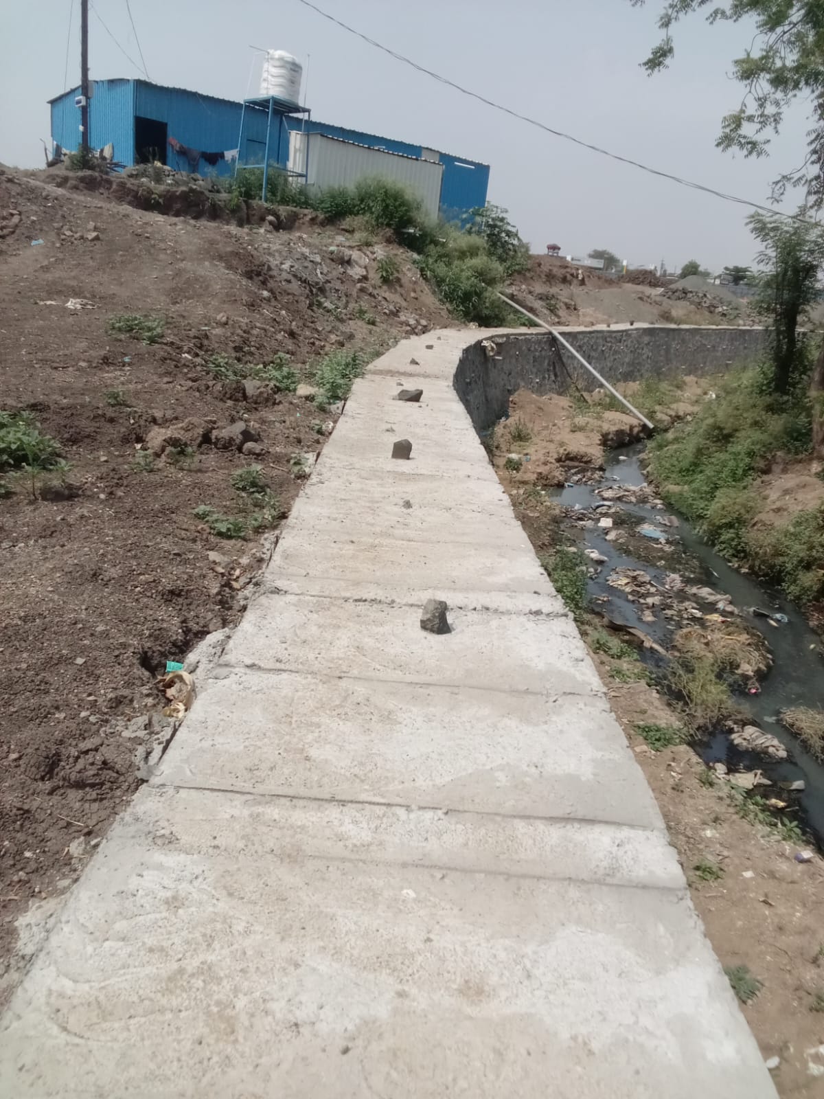 Concrete canal pathway with stone side wall