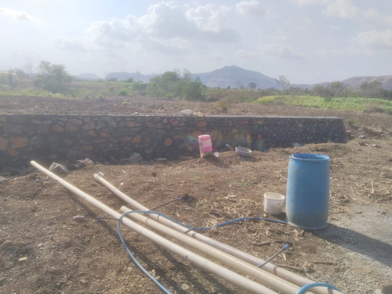 Completed stone retaining wall in a hilly landscape